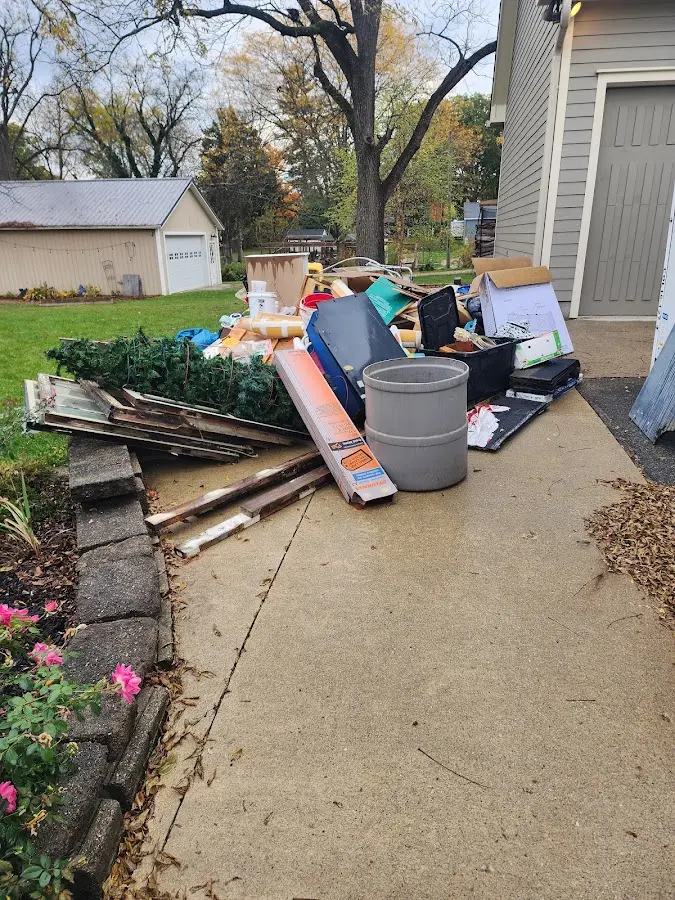 Dumpster being loaded with debris for 12 Yard Dumpster Rental in Edison
